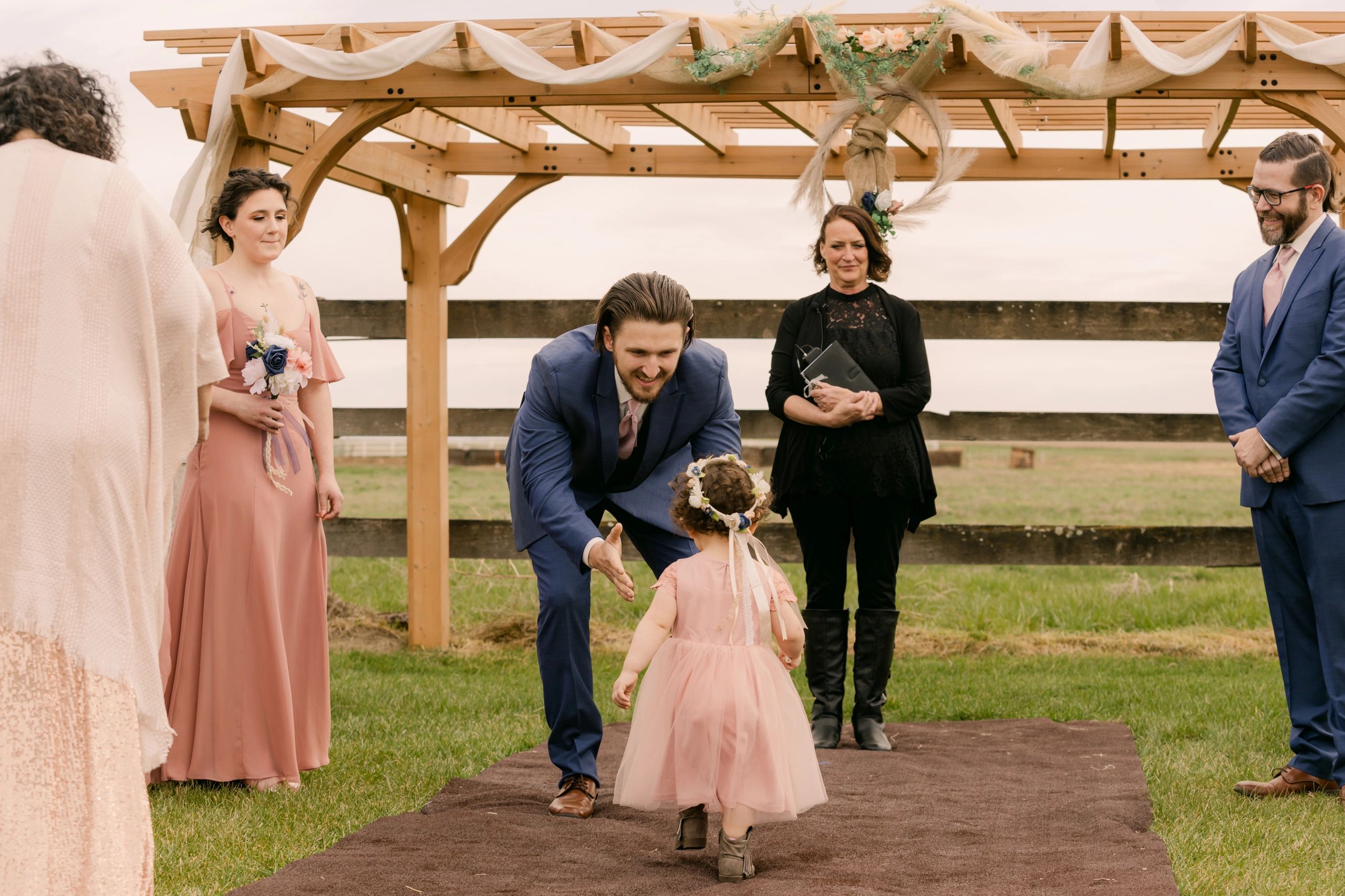 adorable flower girl walking down the aisle at stone ridge estates wedding venue pasco washington wedding venue near me