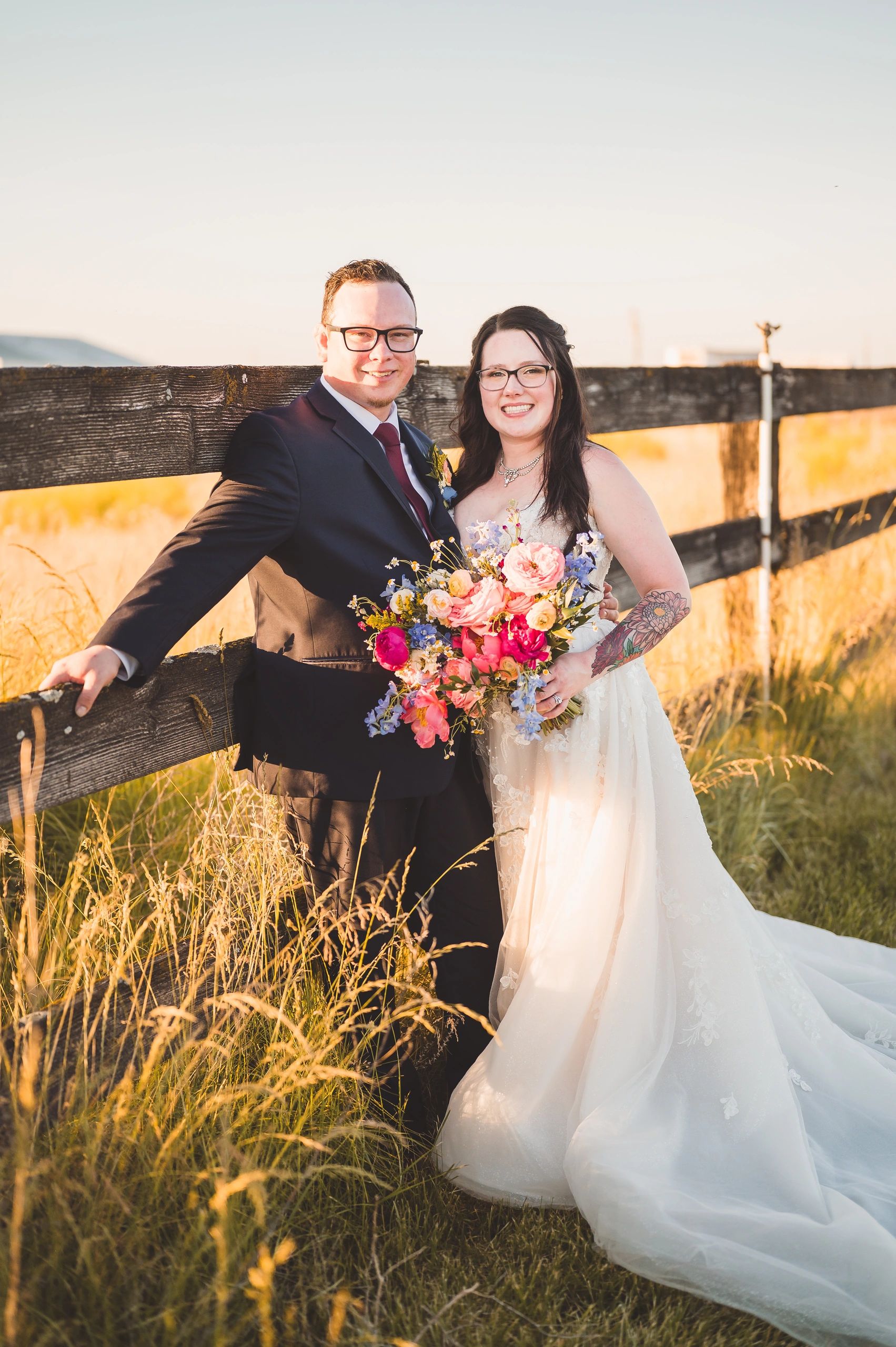 Newlyweds in the pasture during golden hour at Stone Ridge Estates
